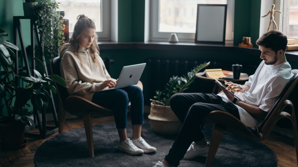 A man and a woman working together on their screenplays.