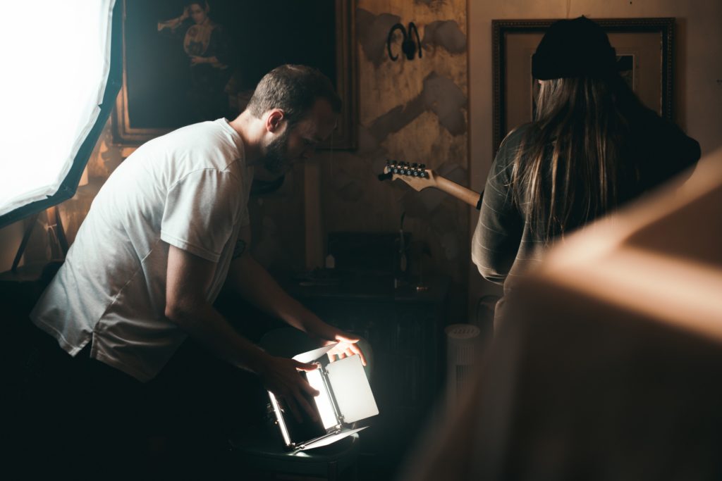 Short film director adjusting the lighting on his set.