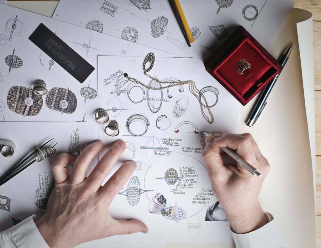 Image of hands, designing a piece of jewelry for a film.