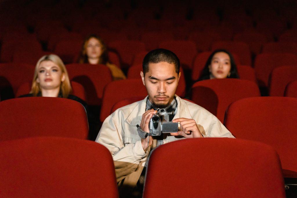 A man in a theater - after his film distribution was successful