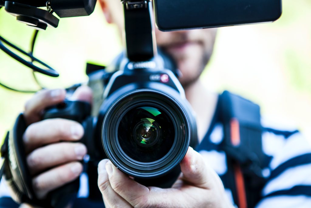 A man holding a movie camera