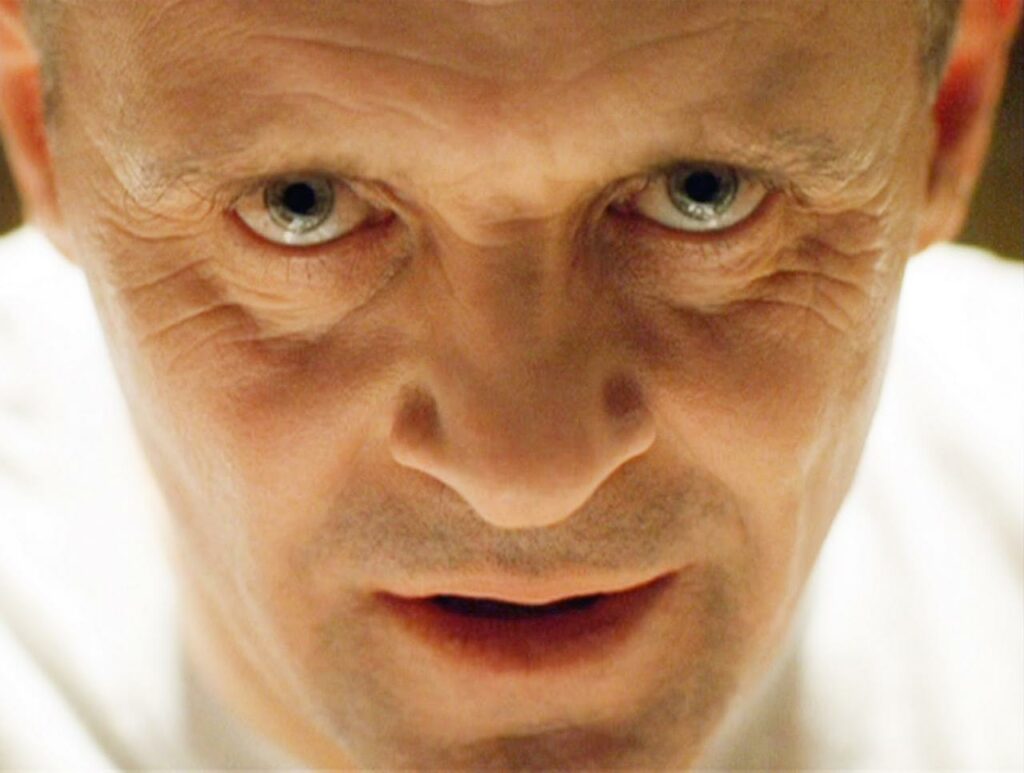 Anthony Hopkins as Hannibal Lecter staring menacingly into the camera, demonstrating the power of casting when it comes to books as movies.