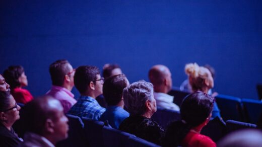 An audience in a theatre watching a film.