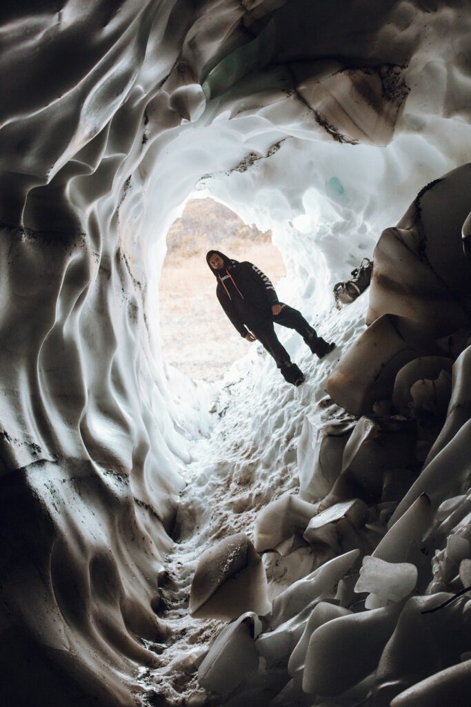 A tilted picture of a man standing in a cave