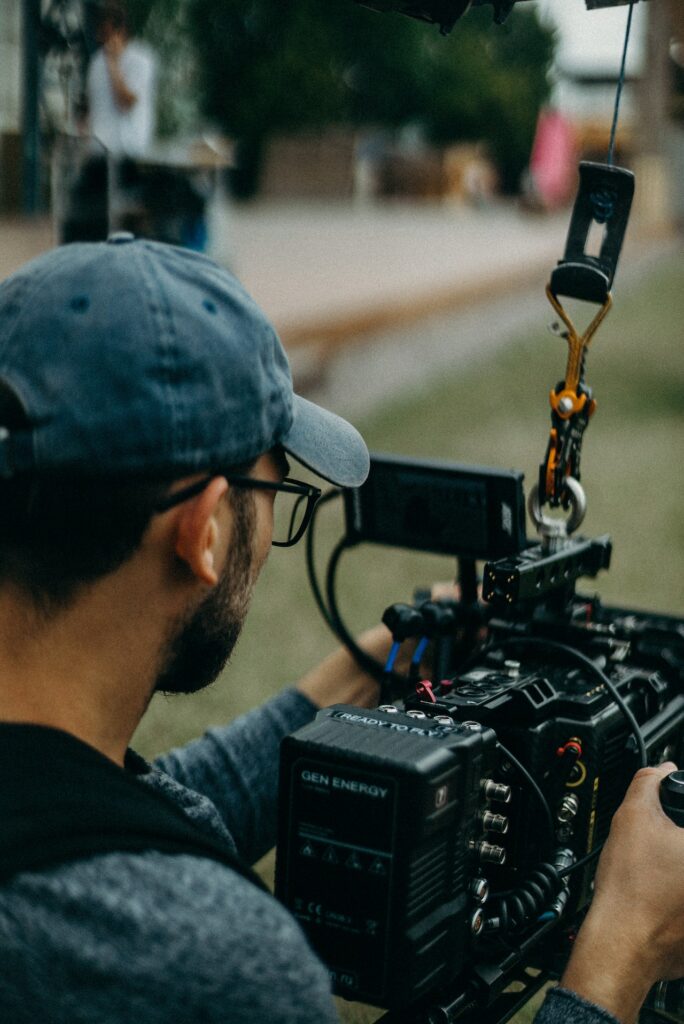 A cameraman manipulating a camera.