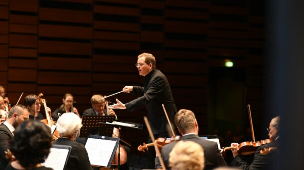 A conductor conducting an orchestra