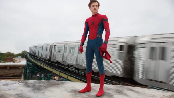Peter Parker unmasked beside a subway train from the movie "Spider-Man: Homecoming"