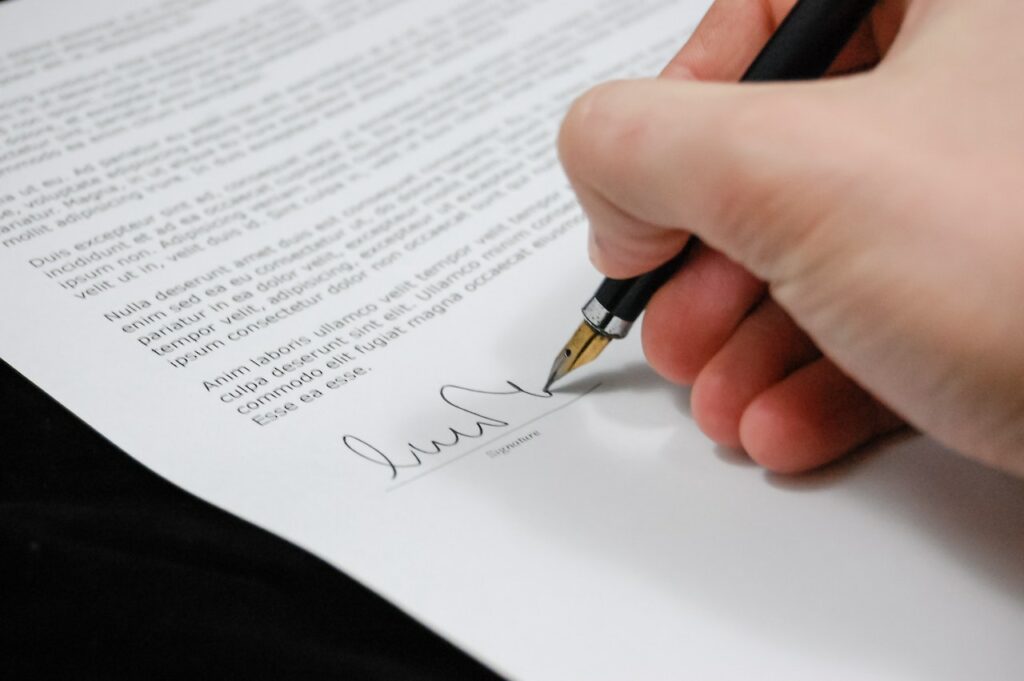 A contract being signed to officiate the distribution of a film.