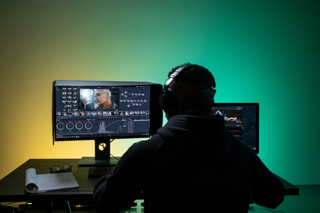 A film editor at work on their dual monitor setup.
