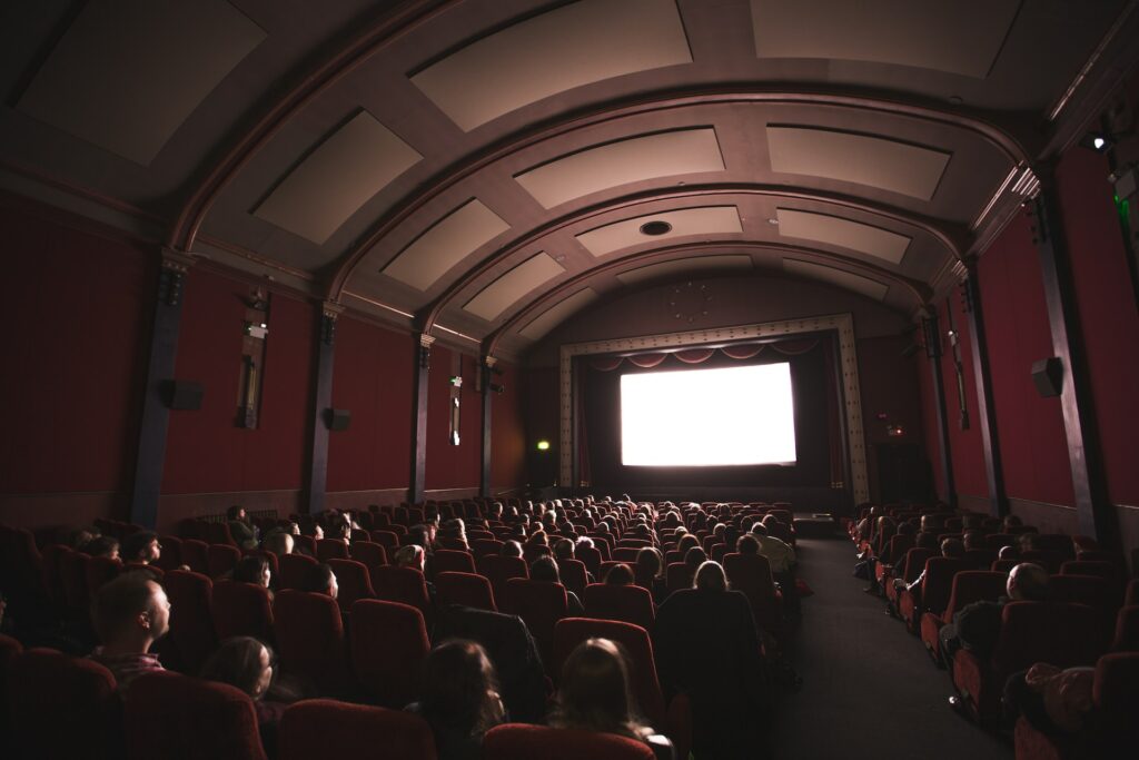 An audience in a theatre engaged in a film due to an unreliable narrator.