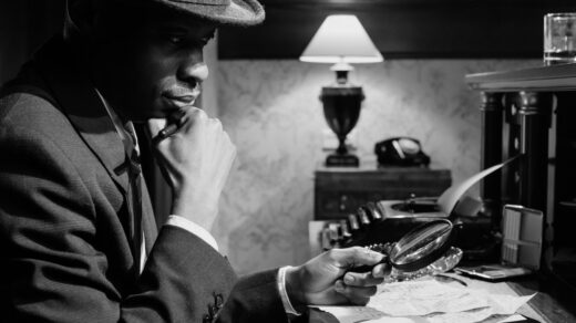 A film noir scene of a 1940s man at a desk.