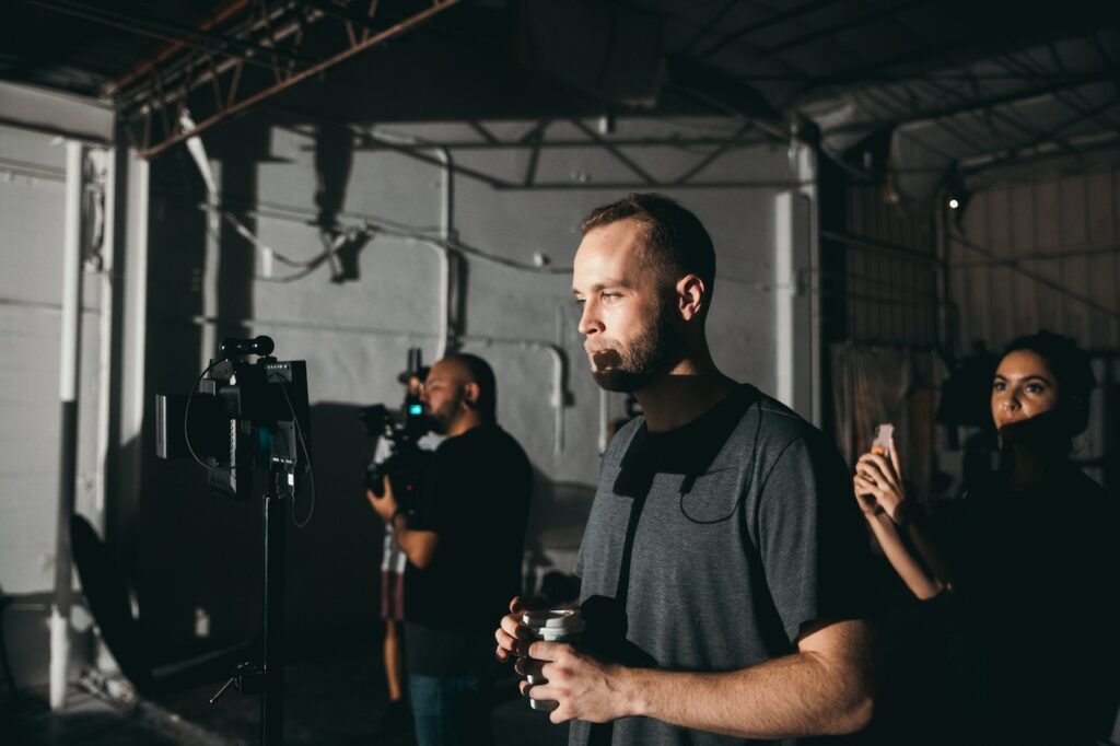 A movie director on set with other filmmakers.