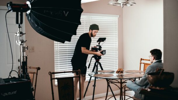 A man setting up an on-camera interview.