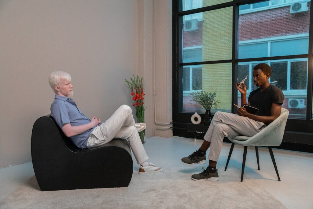 Two people sitting down in a room for an interview.