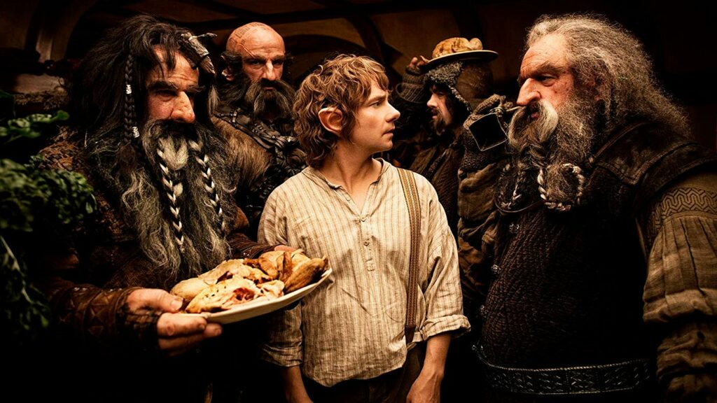 A cast of characters from "The Hobbit" movie prequels standing together.