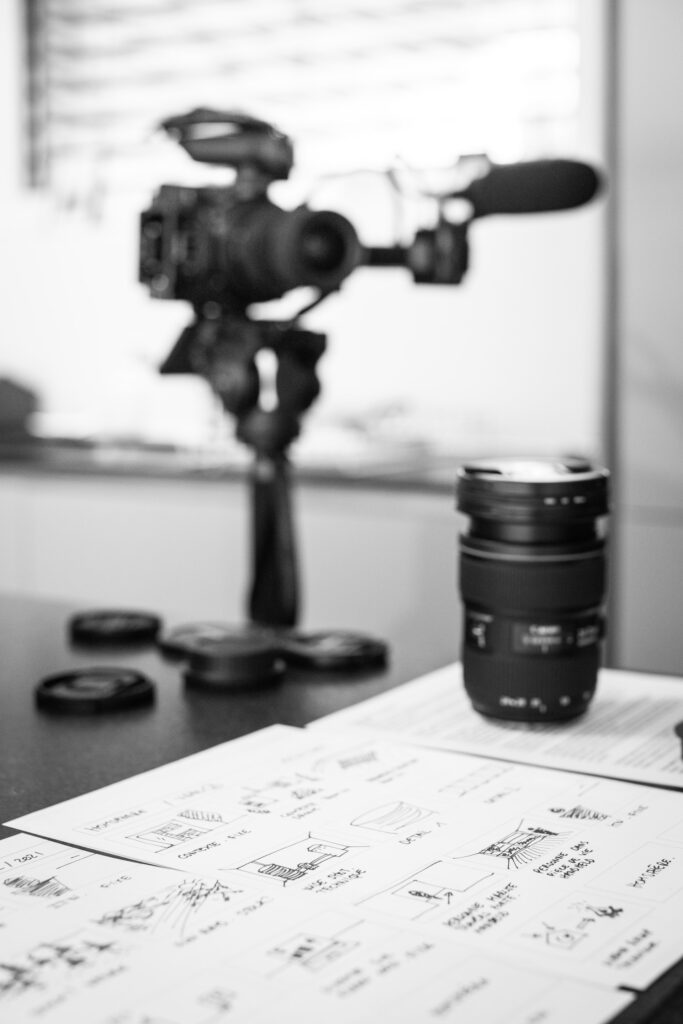 Storyboard next to a camera and lens
