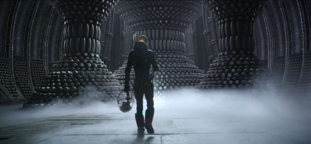 A character from the prequel "Prometheus" standing in a large, alien room.