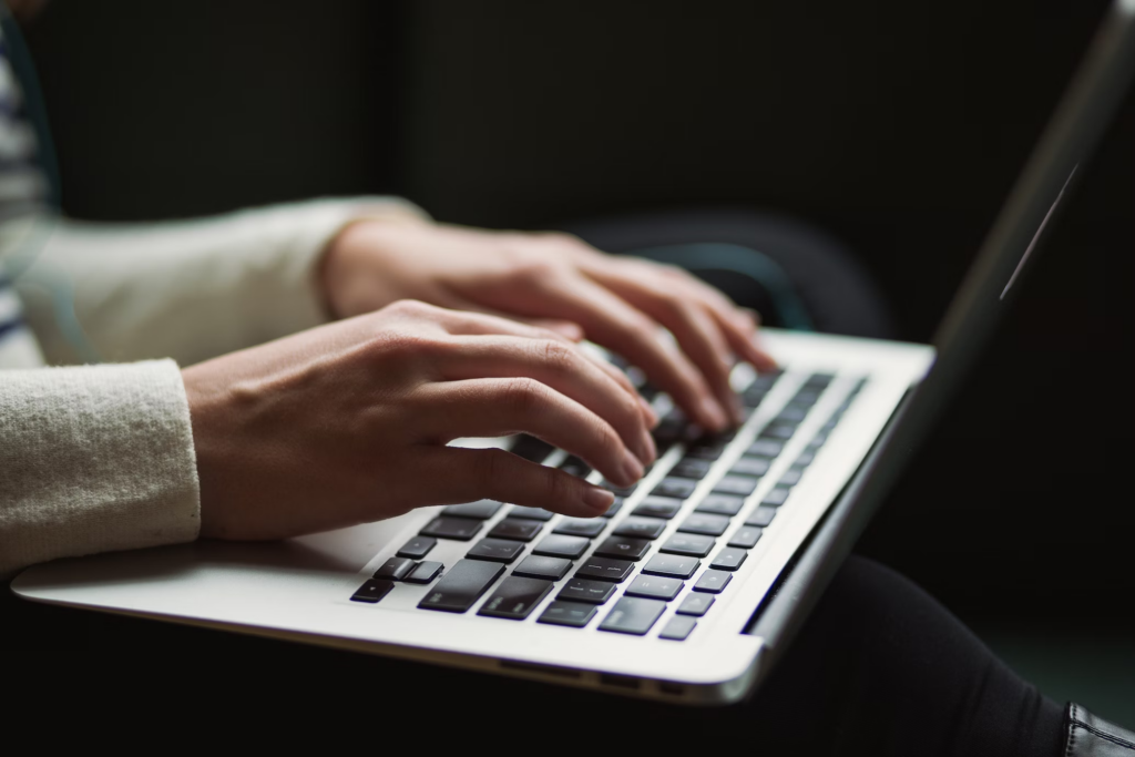 A person writing a script on their laptop.