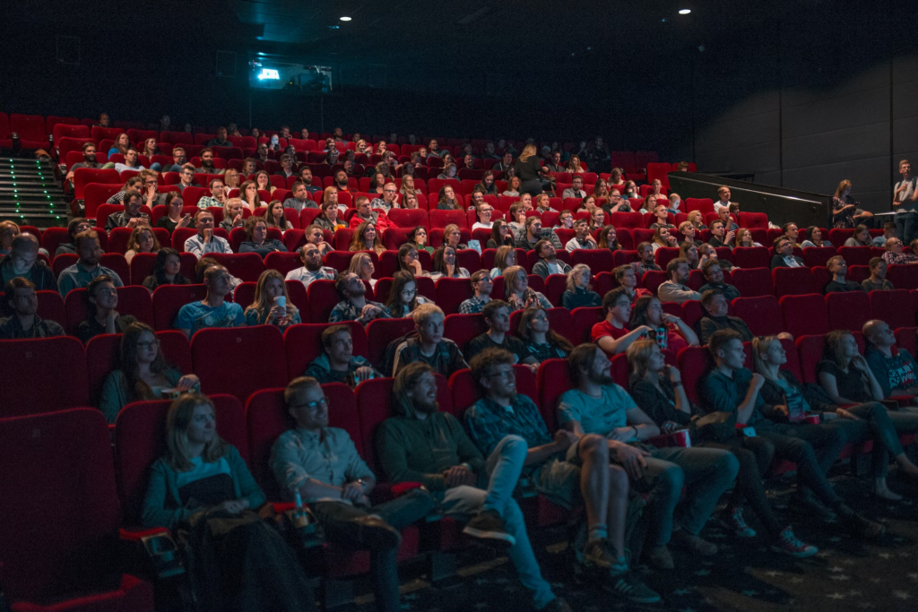 An audience in a theatre watching a movie.