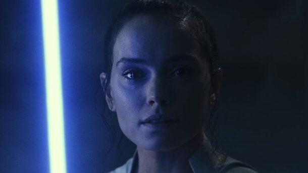 Rey from "Star Wars" holding her lightsaber.