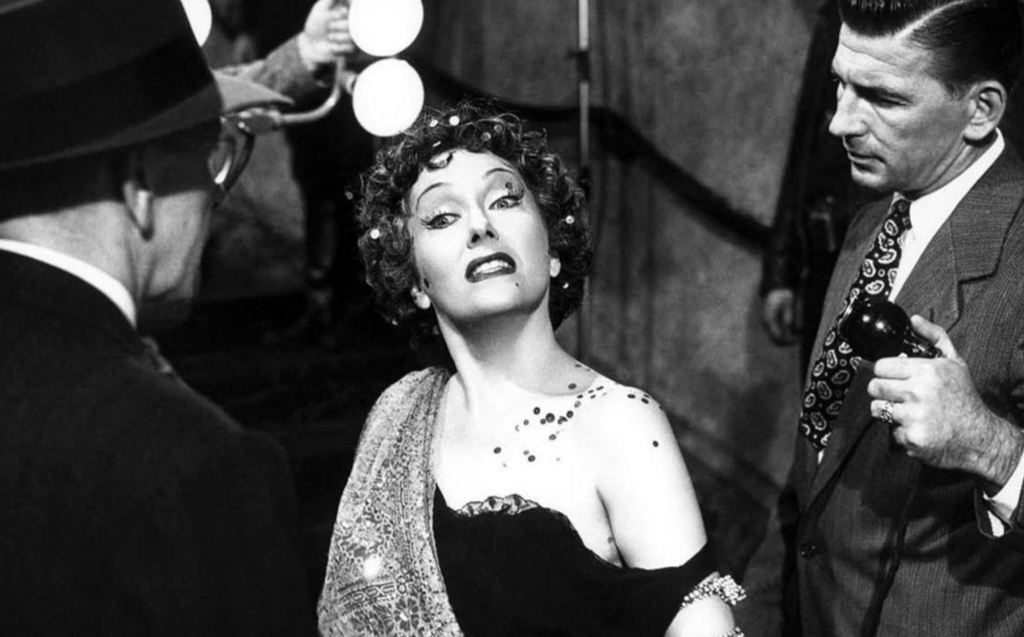 A few characters from the film "Sunset Boulevard" standing together.