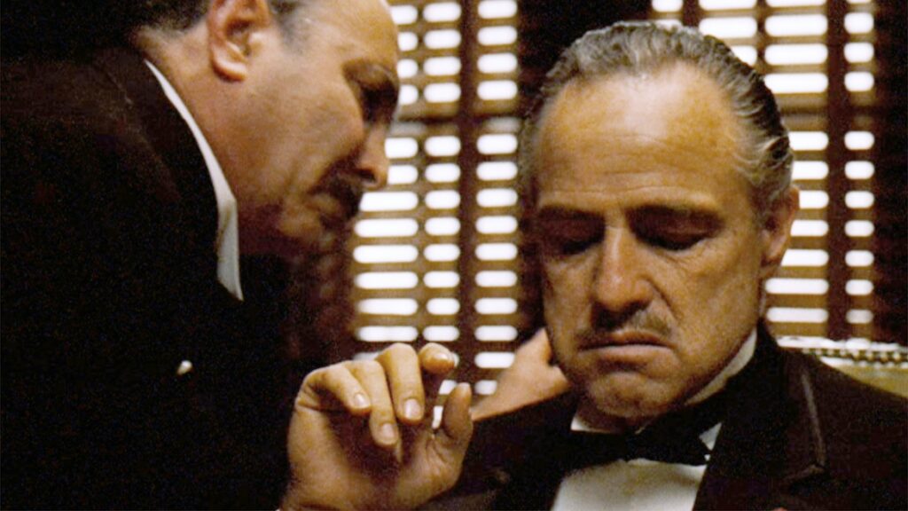Two characters in "The Godfather", a slow-paced masterpiece, talking to one another