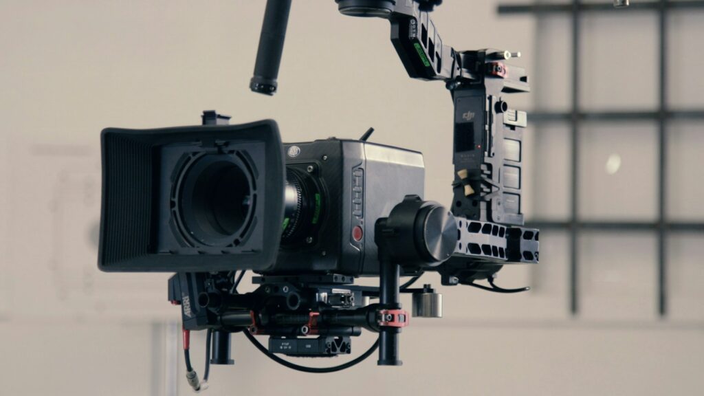 A movie camera mounted on an arm.