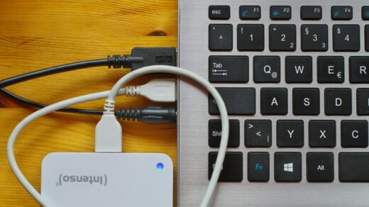 A laptop with a portable hard drive plugged into it.