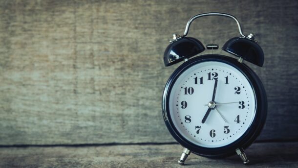 An alarm clock sitting by itself.