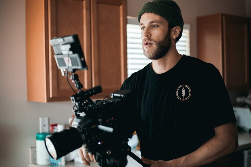 A man filming his documentary in a kitchen.